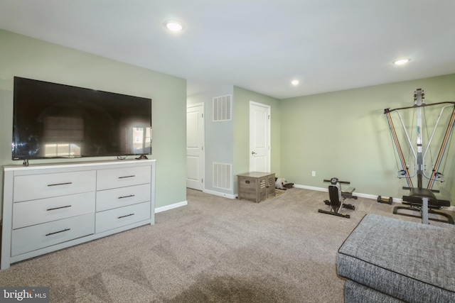 exercise room with light colored carpet