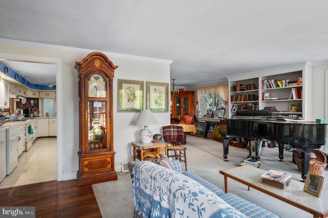 living room featuring crown molding, hardwood / wood-style floors, and an inviting chandelier