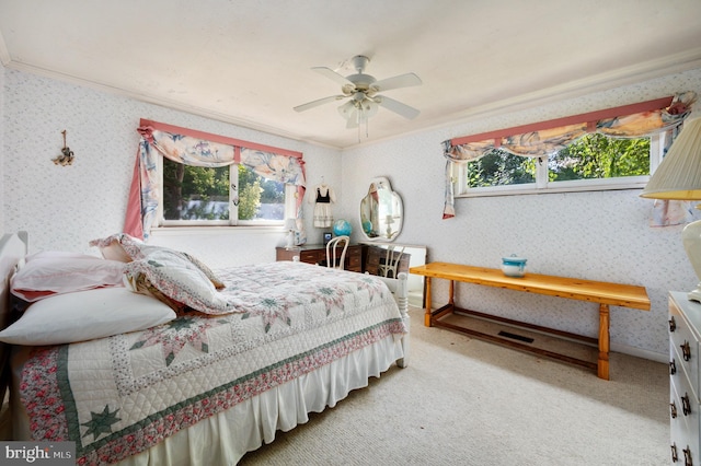 bedroom featuring multiple windows, ceiling fan, carpet, and ornamental molding