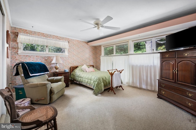 carpeted bedroom with ceiling fan and crown molding