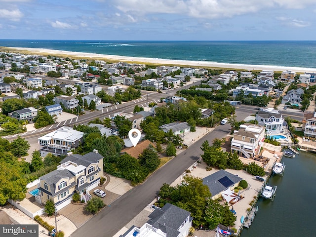 birds eye view of property featuring a water view and a view of the beach