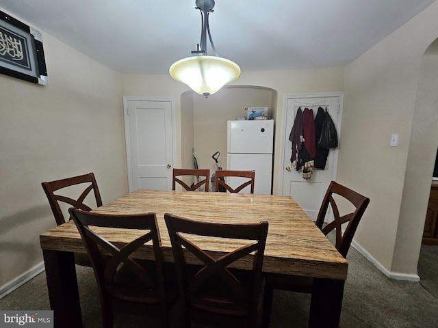 dining space with dark carpet