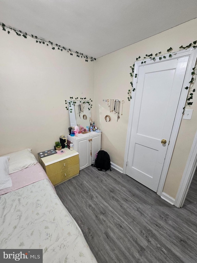 bedroom with dark wood-type flooring