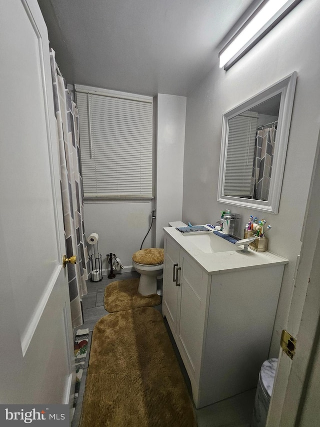 bathroom featuring toilet and vanity