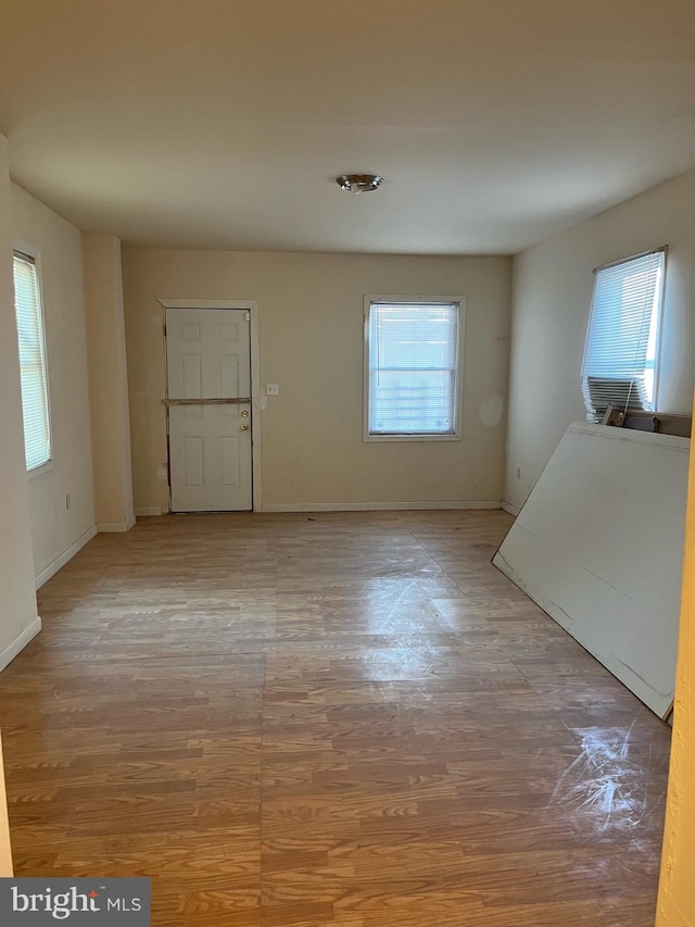 unfurnished room featuring wood finished floors and baseboards