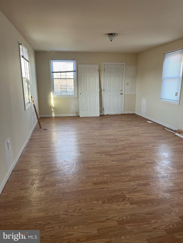 interior space featuring wood finished floors and baseboards