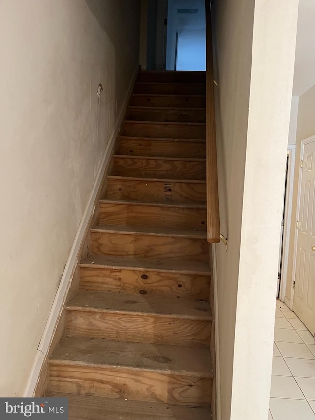 stairs featuring tile patterned floors