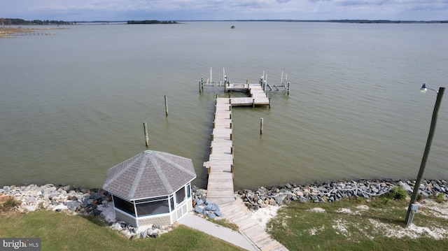 dock area with a water view and boat lift