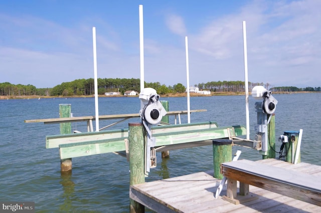 dock area with a water view and boat lift