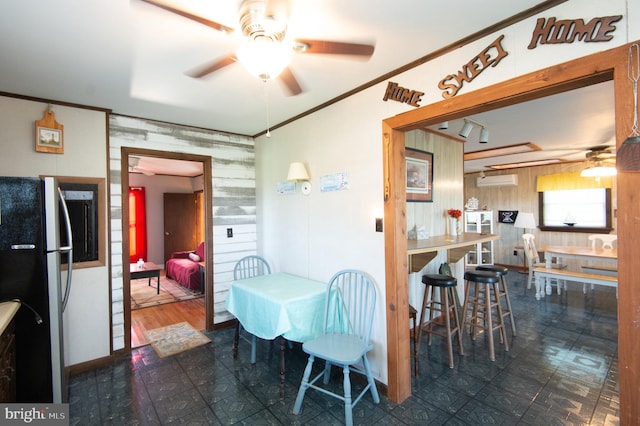 dining space with tile patterned floors, ceiling fan, and crown molding