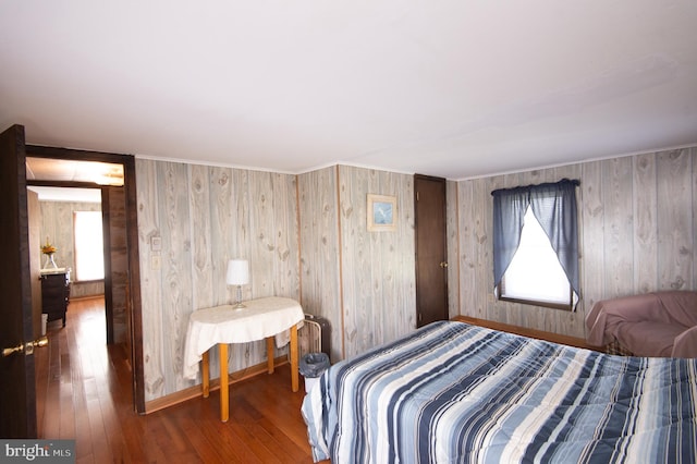 bedroom with multiple windows and hardwood / wood-style floors