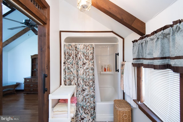 bathroom featuring lofted ceiling with beams, wood finished floors, shower / tub combo with curtain, and ceiling fan