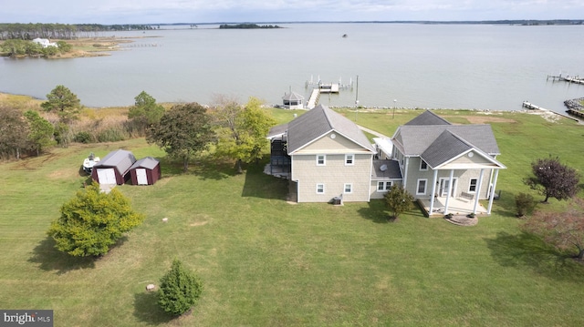 birds eye view of property with a water view