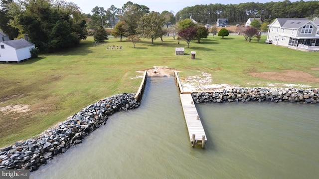 dock area featuring a lawn and a water view