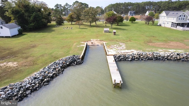 view of dock featuring a water view and a lawn
