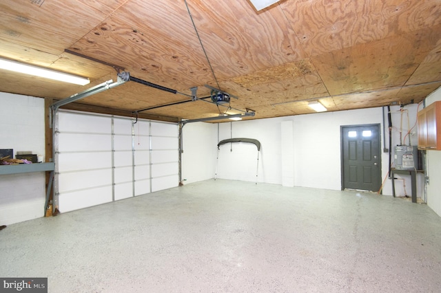 garage featuring wood ceiling and a garage door opener