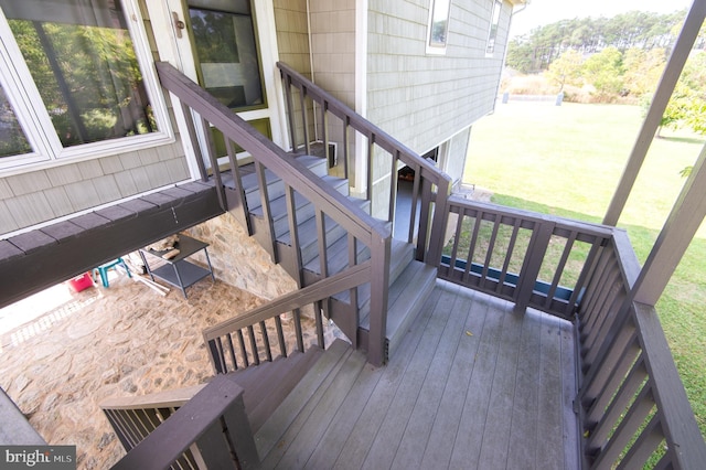 wooden terrace with a lawn and stairs