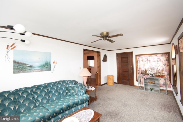 carpeted living room featuring baseboards, a ceiling fan, and ornamental molding