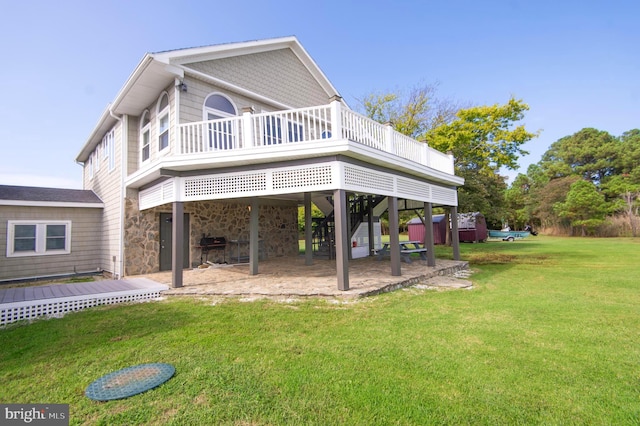 back of house with a yard, a patio area, and a wooden deck