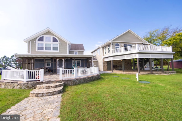 back of property featuring a yard and a patio