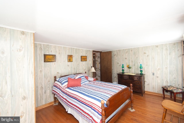 bedroom featuring baseboards and wood finished floors