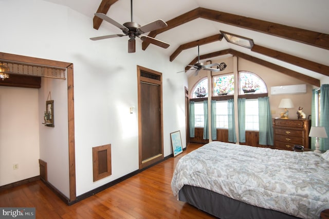 bedroom with an AC wall unit, vaulted ceiling with beams, wood finished floors, and baseboards