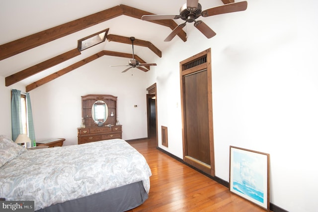 bedroom with a ceiling fan, vaulted ceiling with beams, light wood-style floors, and visible vents