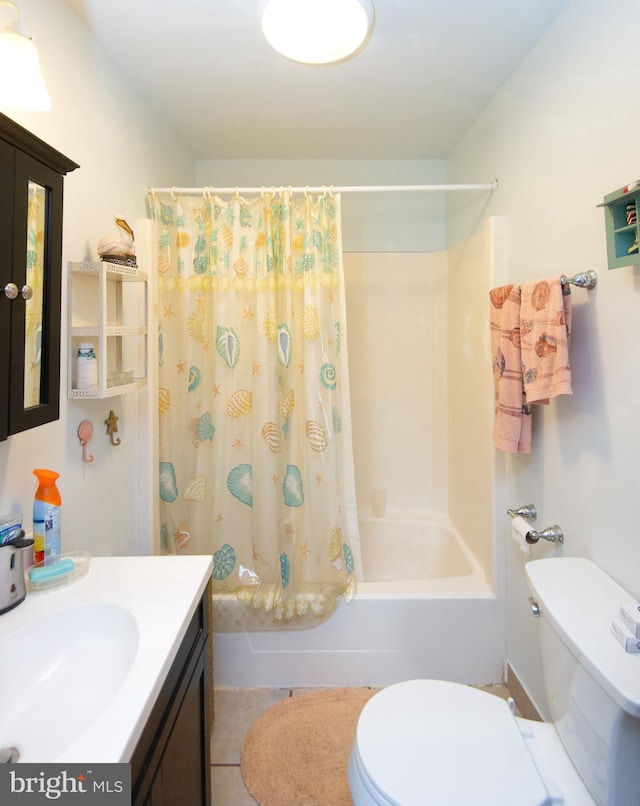 bathroom with tile patterned floors, shower / bath combo with shower curtain, toilet, and vanity