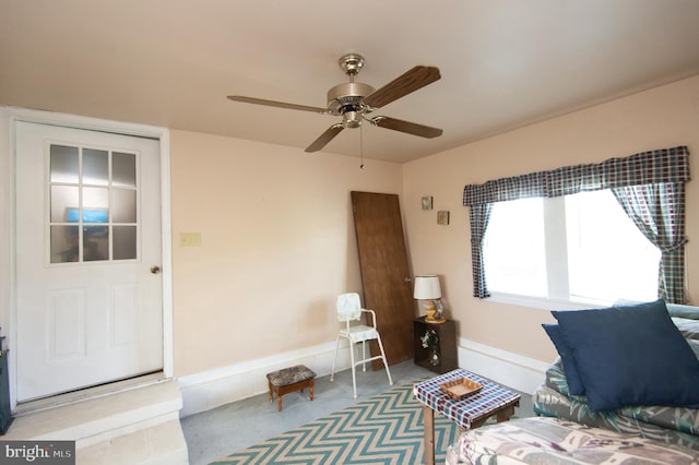 living area featuring carpet flooring and baseboards