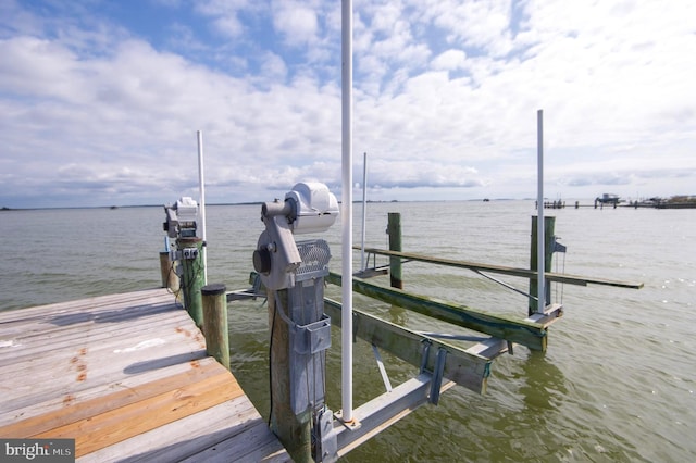 dock area with a water view and boat lift