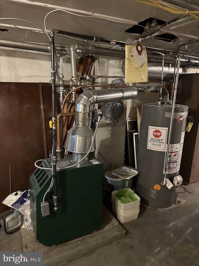 utility room with gas water heater and a heating unit