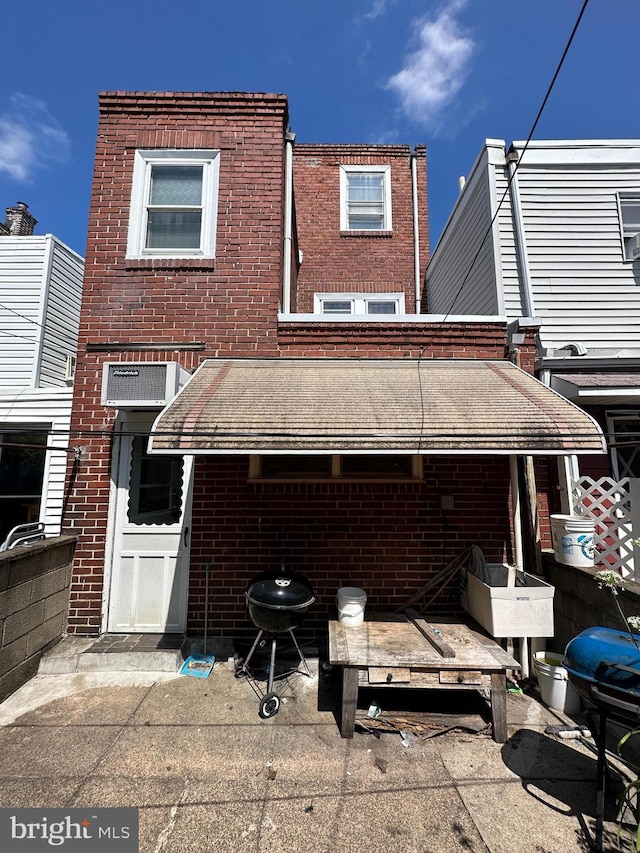 rear view of house featuring brick siding