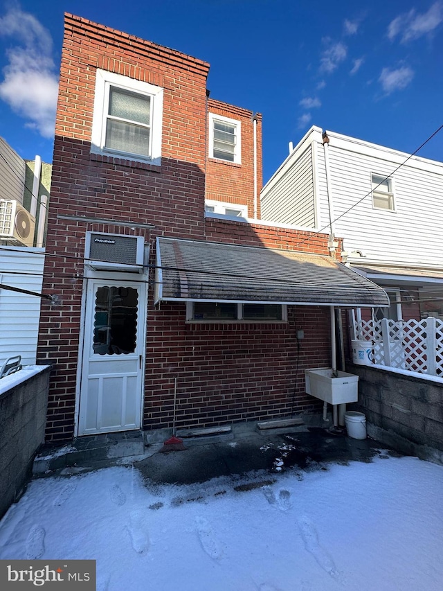 rear view of house with brick siding