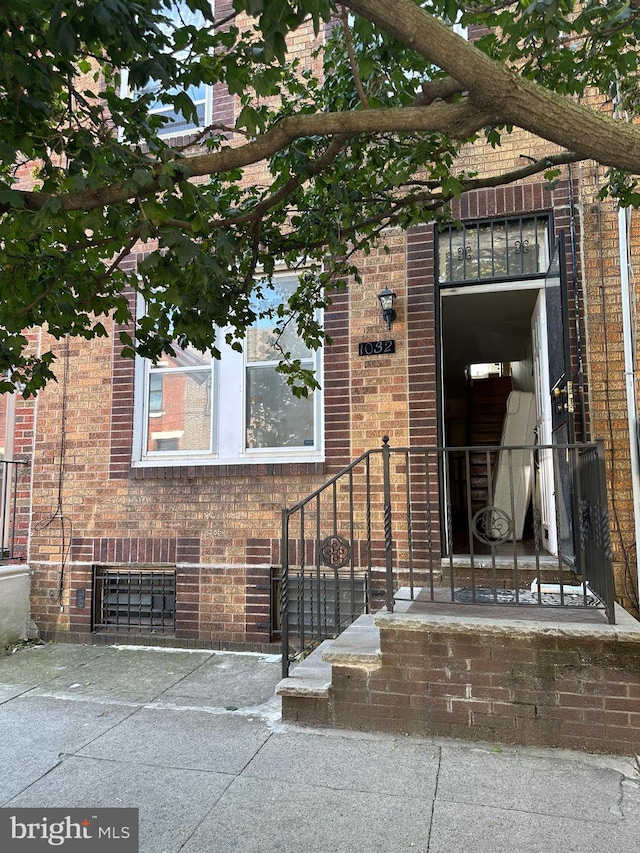 entrance to property with brick siding