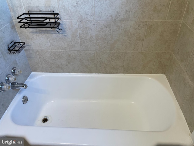 bathroom with a tub to relax in