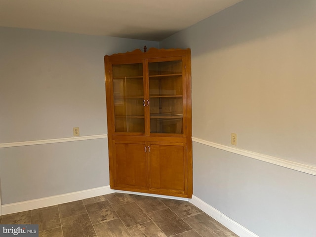 spare room with baseboards