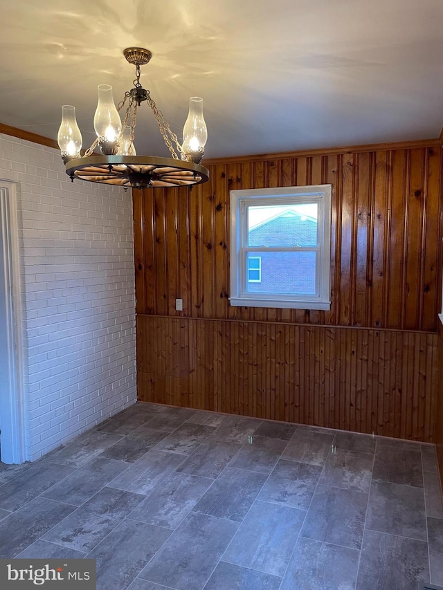 unfurnished dining area with brick wall and wood walls