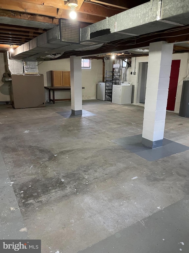 basement featuring heating unit and washing machine and dryer