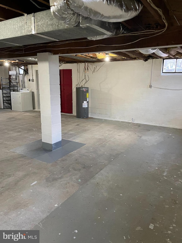 basement featuring separate washer and dryer and electric water heater