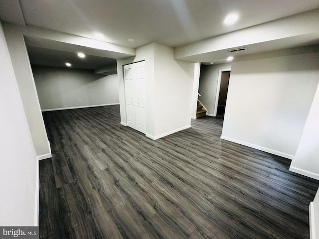 basement featuring dark hardwood / wood-style flooring