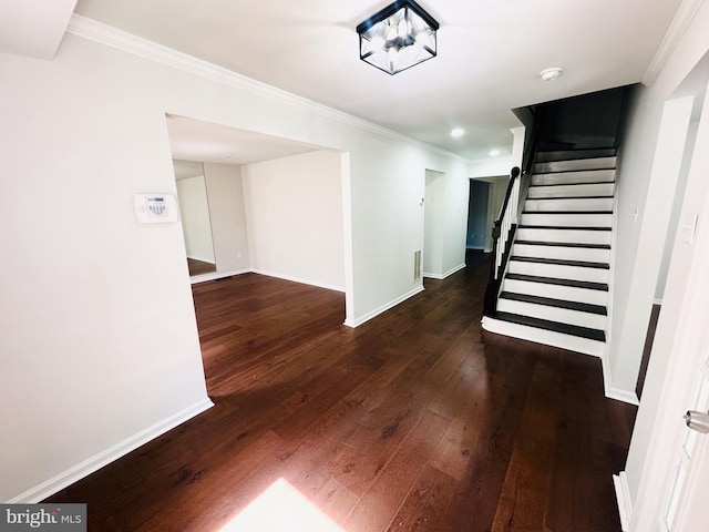 stairs featuring ornamental molding and hardwood / wood-style floors