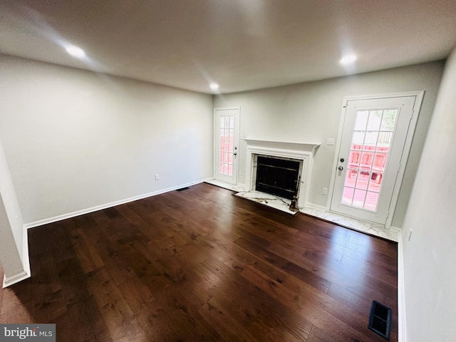 unfurnished living room with dark hardwood / wood-style flooring