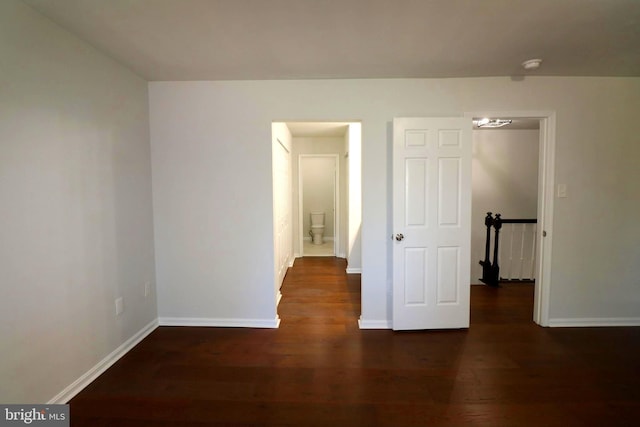 unfurnished room featuring dark wood-type flooring