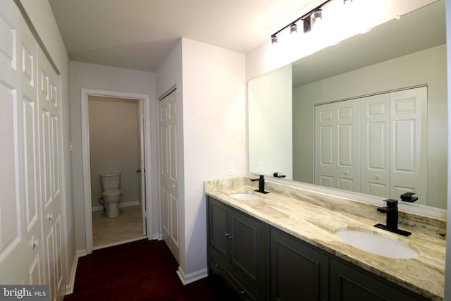 bathroom featuring vanity and toilet