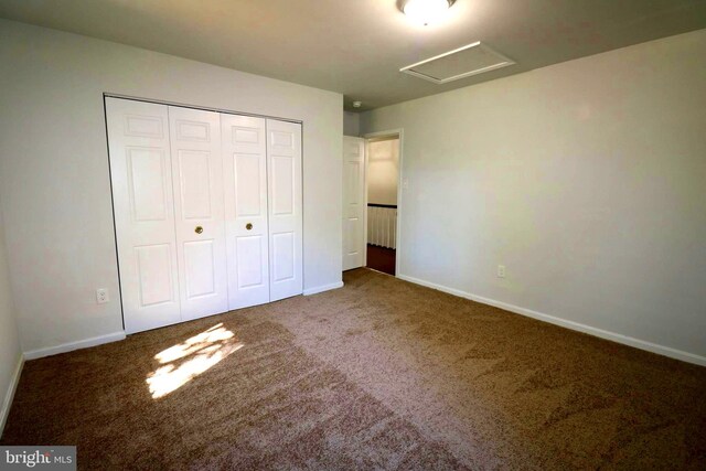 unfurnished bedroom featuring carpet floors and a closet