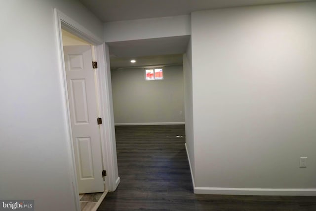 hallway with dark hardwood / wood-style flooring