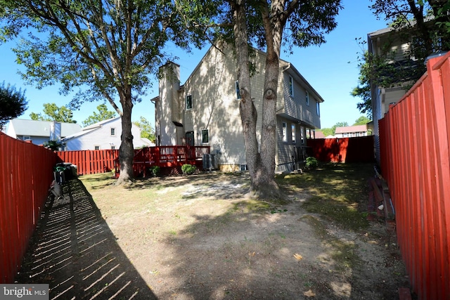 view of yard featuring a deck and central air condition unit