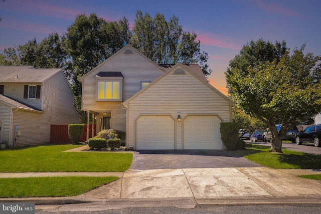 view of front property featuring a lawn and a garage