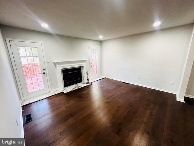 unfurnished living room with dark hardwood / wood-style floors