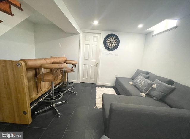 living room with dark tile patterned flooring